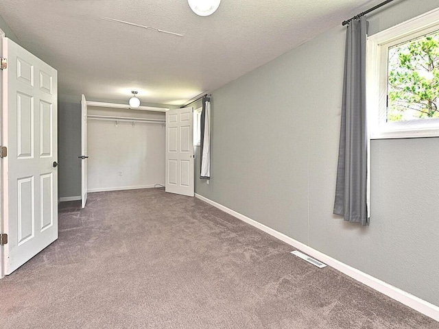 21327 Keyview Rd, Grand Rapids, MN 55744 - unfurnished bedroom with carpet, baseboards, a closet, and a textured ceiling
