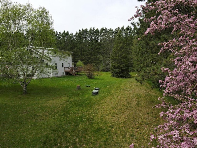 21327 Keyview Rd, Grand Rapids, MN 55744 - view of green lawn with stairway, a wooden deck, and a wooded view