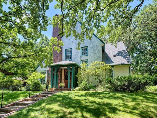 25 Benhill Rd, Saint Paul, MN 55105 - view of front of property featuring stucco siding, a chimney, and roof with shingles
