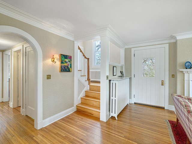 25 Benhill Rd, Saint Paul, MN 55105 - entryway featuring radiator, light wood-style floors, plenty of natural light, crown molding, and arched walkways