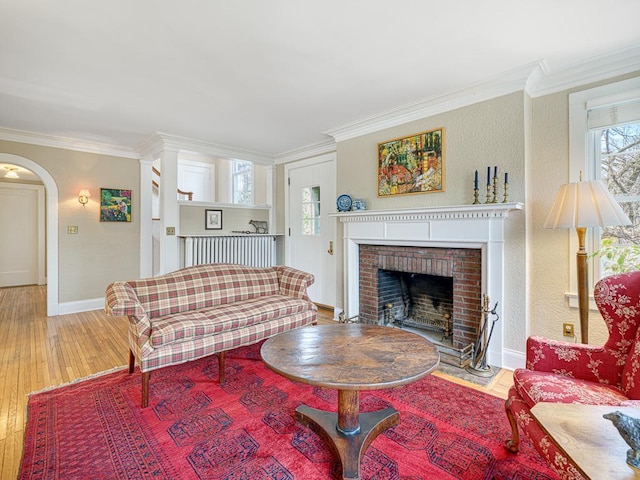 25 Benhill Rd, Saint Paul, MN 55105 - living room featuring ornamental molding, a brick fireplace, wood finished floors, and arched walkways