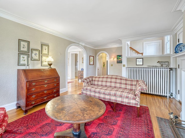 25 Benhill Rd, Saint Paul, MN 55105 - living area with arched walkways, wood finished floors, radiator, crown molding, and a textured wall