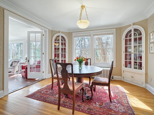 25 Benhill Rd, Saint Paul, MN 55105 - dining area with healthy amount of natural light, light wood-type flooring, crown molding, radiator heating unit, and a textured wall