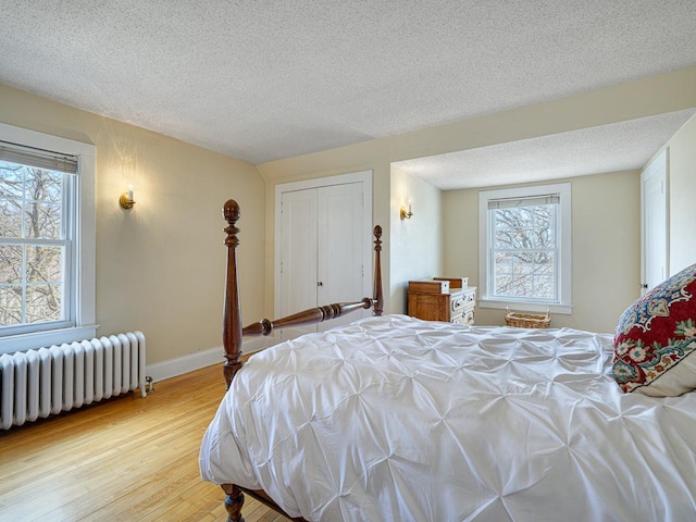 25 Benhill Rd, Saint Paul, MN 55105 - bedroom with radiator, wood finished floors, a textured ceiling, and a closet