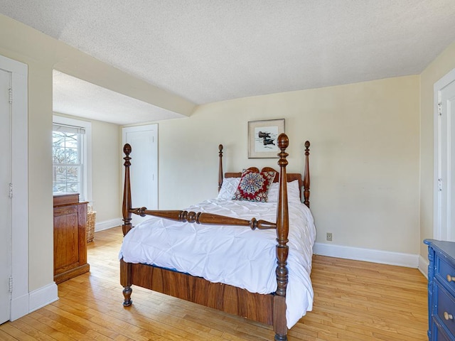 25 Benhill Rd, Saint Paul, MN 55105 - bedroom featuring light wood-type flooring and a textured ceiling