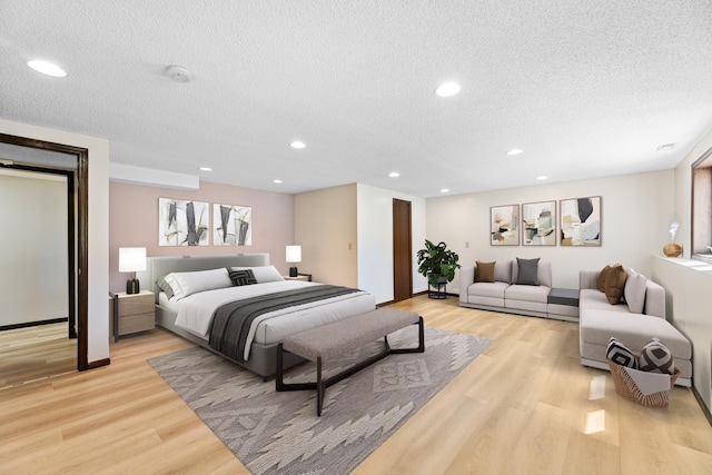 436 Bruns Ct, Vadnais Heights, MN 55127 - bedroom with a textured ceiling, light wood-style floors, recessed lighting, and baseboards