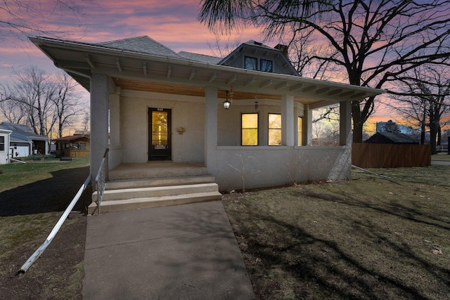 view of front of home with covered porch and stucco siding