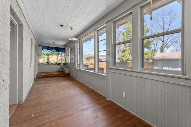 unfurnished sunroom with wood-type flooring