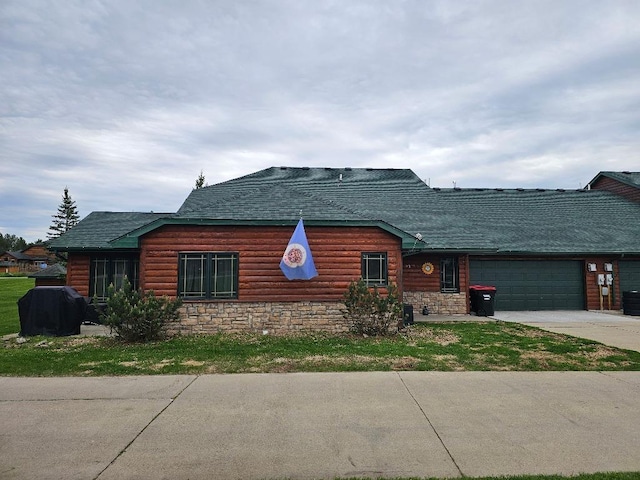 20371 Golf Crest Dr, Grand Rapids, MN 55744 - log-style house with a garage, concrete driveway, roof with shingles, and stone siding