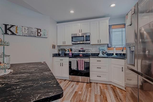 20371 Golf Crest Dr, Grand Rapids, MN 55744 - kitchen with appliances with stainless steel finishes, a sink, white cabinets, decorative backsplash, and recessed lighting