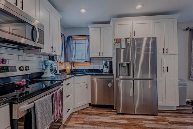 20371 Golf Crest Dr, Grand Rapids, MN 55744 - kitchen with stainless steel appliances, recessed lighting, a sink, white cabinets, and dark countertops