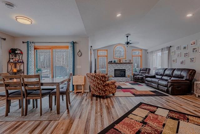 20371 Golf Crest Dr, Grand Rapids, MN 55744 - living area with ceiling fan, wood finished floors, a stone fireplace, and lofted ceiling