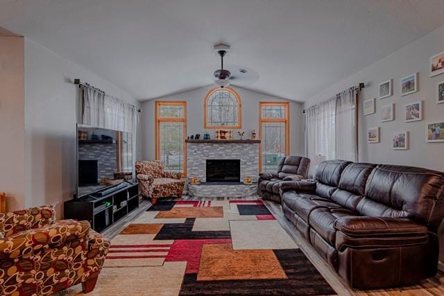 20371 Golf Crest Dr, Grand Rapids, MN 55744 - living room with a stone fireplace, lofted ceiling, ceiling fan, and wood finished floors