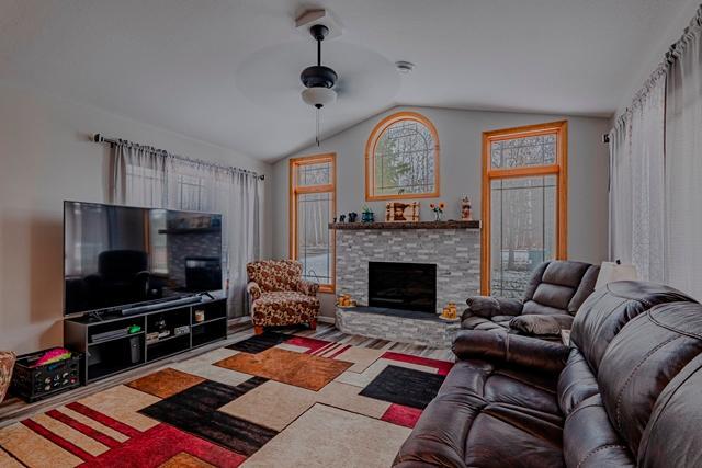 20371 Golf Crest Dr, Grand Rapids, MN 55744 - living room featuring a ceiling fan, lofted ceiling, and a fireplace
