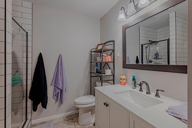 20371 Golf Crest Dr, Grand Rapids, MN 55744 - bathroom featuring a stall shower, toilet, and vanity