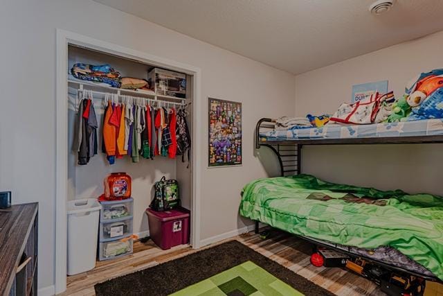20371 Golf Crest Dr, Grand Rapids, MN 55744 - bedroom featuring baseboards, wood finished floors, and a closet