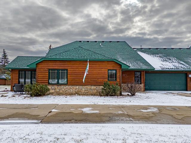 20371 Golf Crest Dr, Grand Rapids, MN 55744 - view of front facade with an attached garage, faux log siding, and a shingled roof