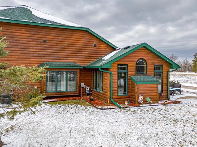 20371 Golf Crest Dr, Grand Rapids, MN 55744 - snow covered back of property with log veneer siding