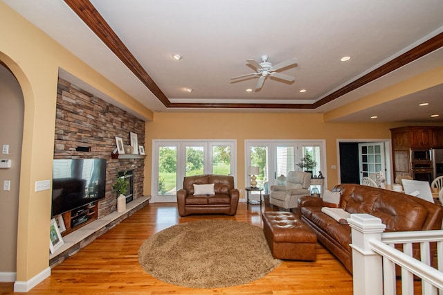 241 Cottonwood Cv, Lynd, MN 56157 - living room featuring a ceiling fan, a raised ceiling, ornamental molding, and light wood finished floors