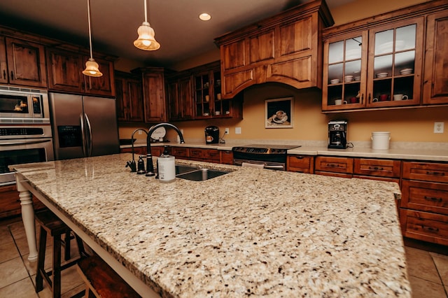 241 Cottonwood Cv, Lynd, MN 56157 - kitchen with light tile patterned flooring, light stone counters, a sink, and stainless steel appliances