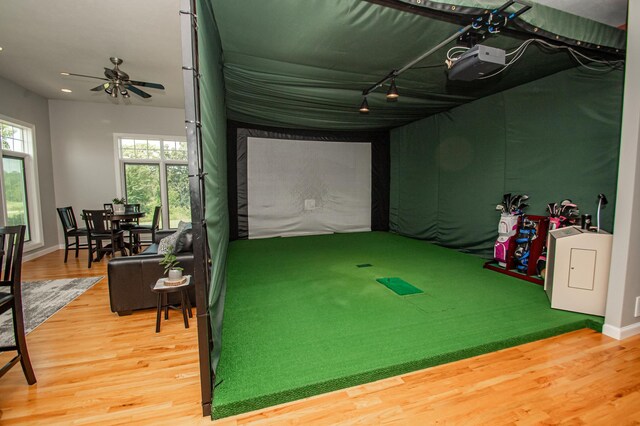 241 Cottonwood Cv, Lynd, MN 56157 - rec room with golf simulator, baseboards, washer / dryer, track lighting, and wood finished floors