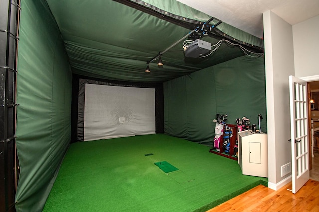 241 Cottonwood Cv, Lynd, MN 56157 - rec room with visible vents, rail lighting, wood finished floors, golf simulator, and washer / dryer