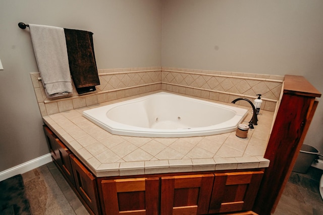 241 Cottonwood Cv, Lynd, MN 56157 - bathroom featuring baseboards and a tub with jets