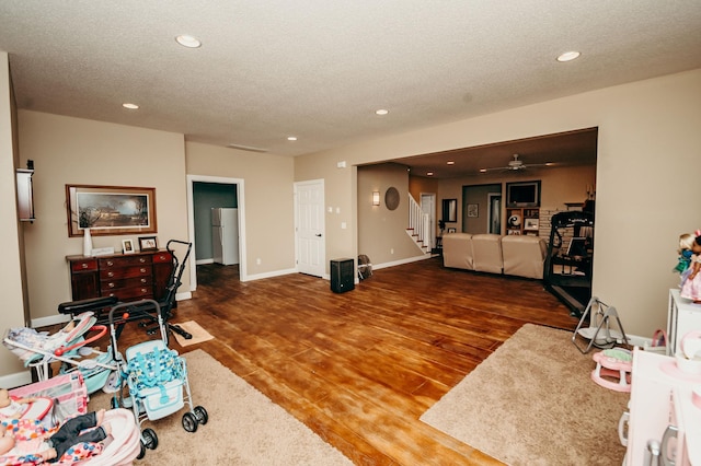 241 Cottonwood Cv, Lynd, MN 56157 - living area featuring stairs, wood finished floors, recessed lighting, and a textured ceiling