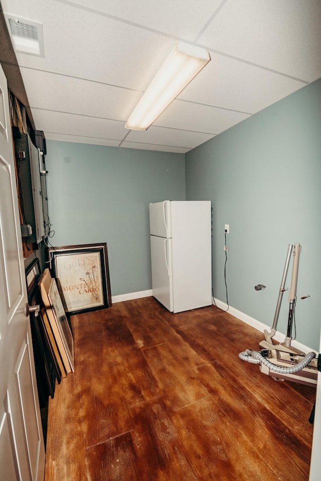 241 Cottonwood Cv, Lynd, MN 56157 - interior space featuring visible vents, baseboards, wood finished floors, a drop ceiling, and freestanding refrigerator