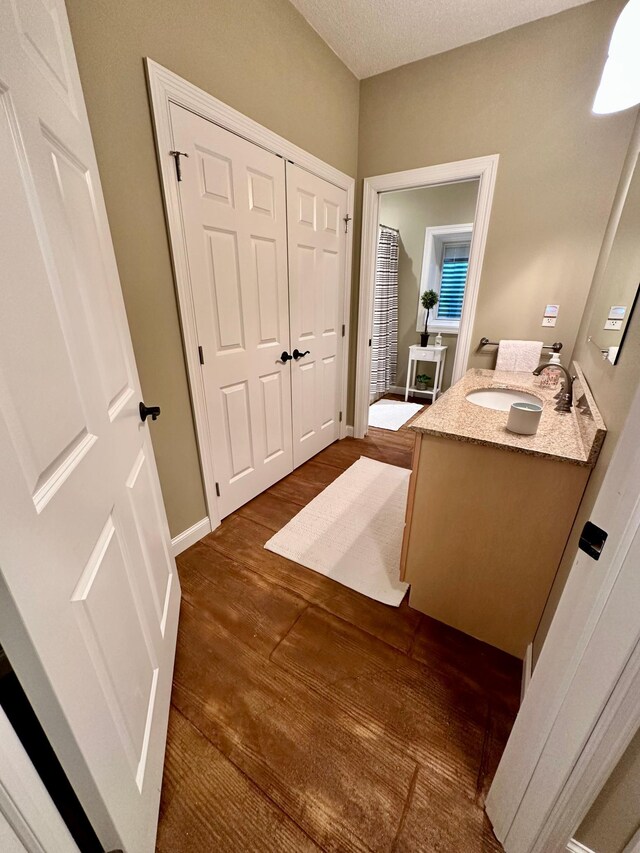 241 Cottonwood Cv, Lynd, MN 56157 - bathroom with baseboards, wood finished floors, and vanity