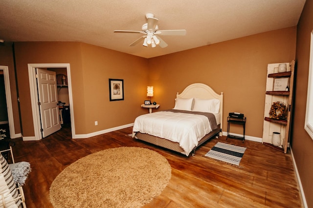 241 Cottonwood Cv, Lynd, MN 56157 - bedroom with baseboards, wood finished floors, a spacious closet, and a ceiling fan