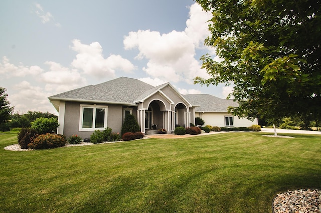 241 Cottonwood Cv, Lynd, MN 56157 - view of front of property with stucco siding, roof with shingles, and a front yard