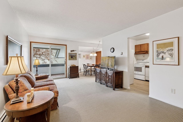 living room with light colored carpet, a textured ceiling, and baseboard heating