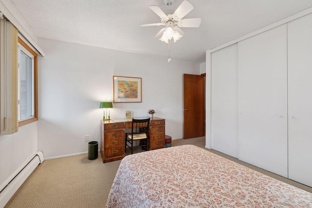 bedroom with ceiling fan, carpet floors, baseboards, a closet, and a baseboard heating unit