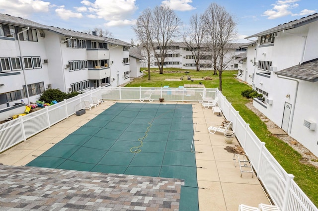 pool with fence and a residential view