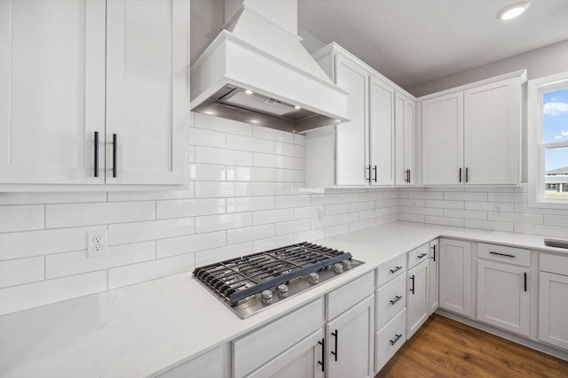 1531 Clover Preserve Way, Chaska, MN 55318 - kitchen featuring white cabinets, light countertops, custom exhaust hood, stainless steel gas cooktop, and backsplash