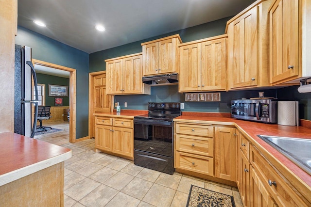 kitchen with light brown cabinets, light tile patterned floors, under cabinet range hood, stainless steel appliances, and a sink