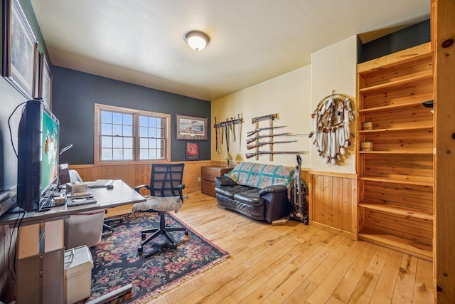 office space with wooden walls, hardwood / wood-style floors, and a wainscoted wall