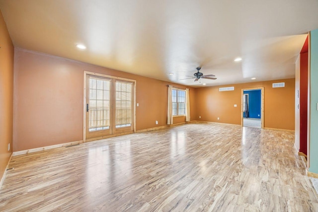 unfurnished room with light wood finished floors, visible vents, baseboards, and ceiling fan