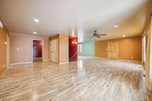 unfurnished living room featuring recessed lighting, light wood-type flooring, baseboards, and ceiling fan