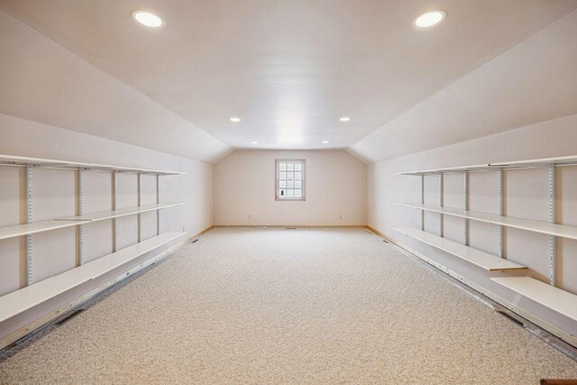 additional living space featuring baseboards, carpet, lofted ceiling, and recessed lighting