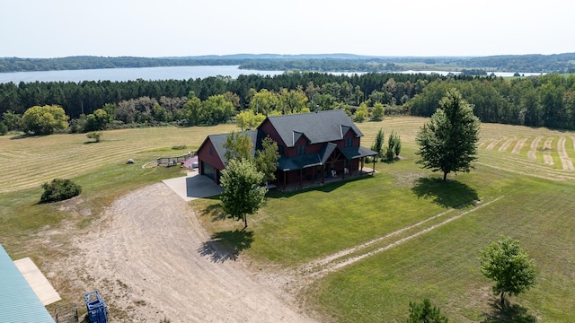 bird's eye view featuring a wooded view, a water view, and a rural view