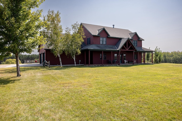 view of front of home with a garage, a front yard, faux log siding, and covered porch