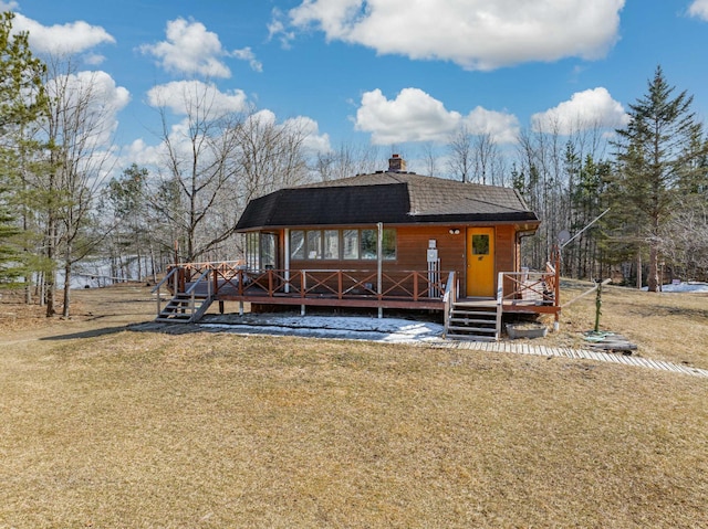 34130 Deer Lake Rd, Grand Rapids, MN 55744 - view of front of house with a front lawn, a deck, and a chimney