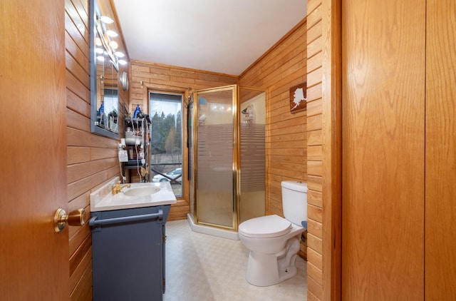 34130 Deer Lake Rd, Grand Rapids, MN 55744 - bathroom with wooden walls, vanity, toilet, a shower stall, and tile patterned floors
