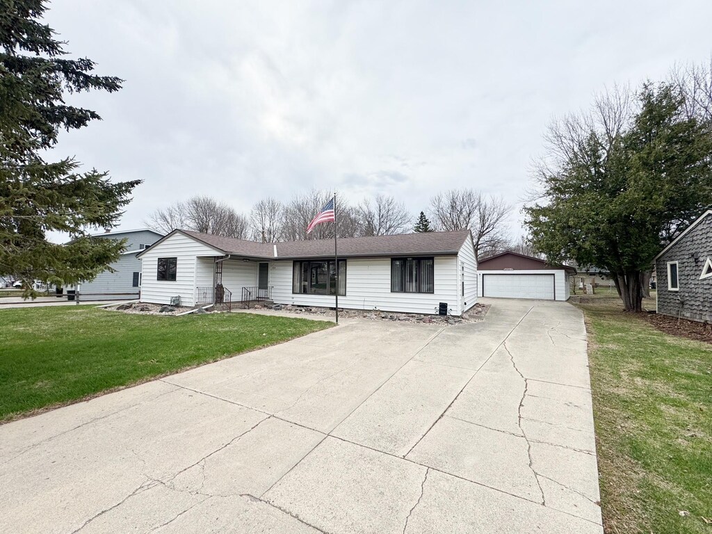 1525 Shore Dr, Worthington, MN 56187 - ranch-style house featuring a front lawn, an outbuilding, and a detached garage