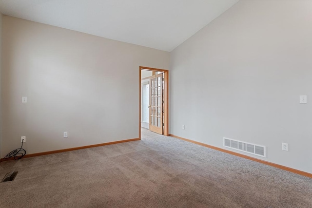 unfurnished room with baseboards, light colored carpet, and lofted ceiling