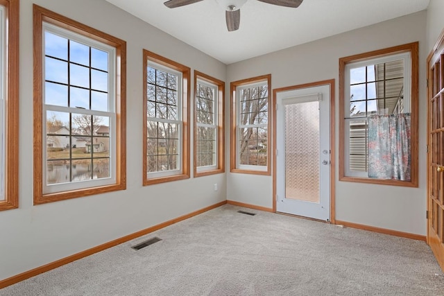 spare room with carpet, baseboards, and ceiling fan