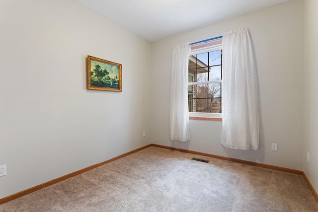 spare room with carpet flooring and baseboards