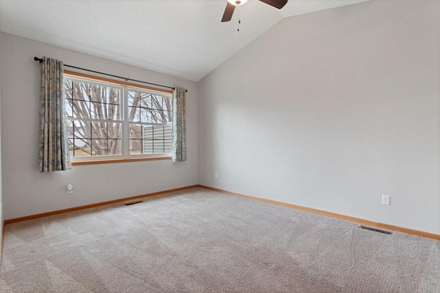 carpeted spare room with a ceiling fan, lofted ceiling, and baseboards